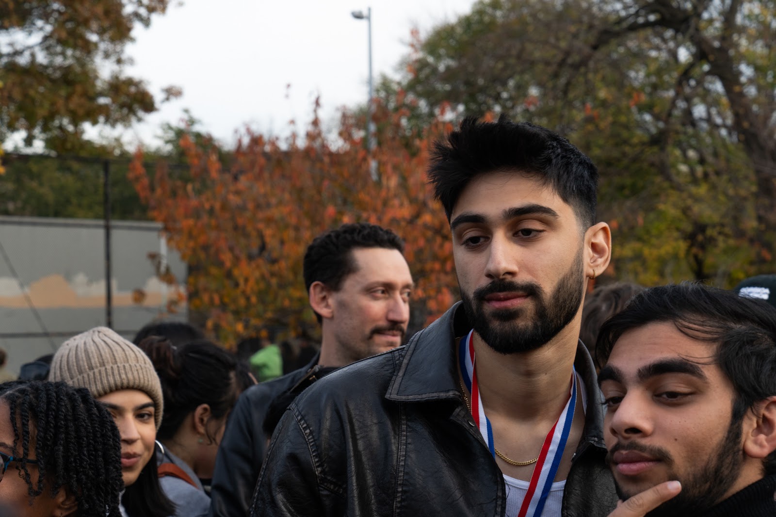 An image of the third runner-up at the Zayn Malik look-alike contest, posing for a photo with a crowd member.