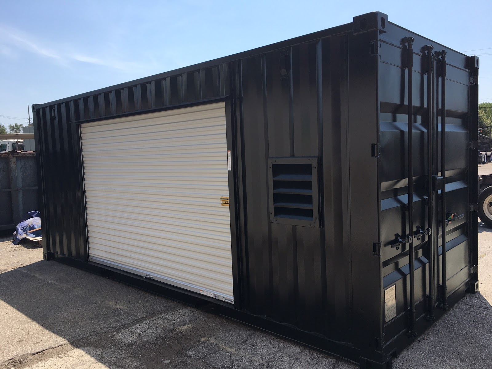 black shipping container shed with sliding door