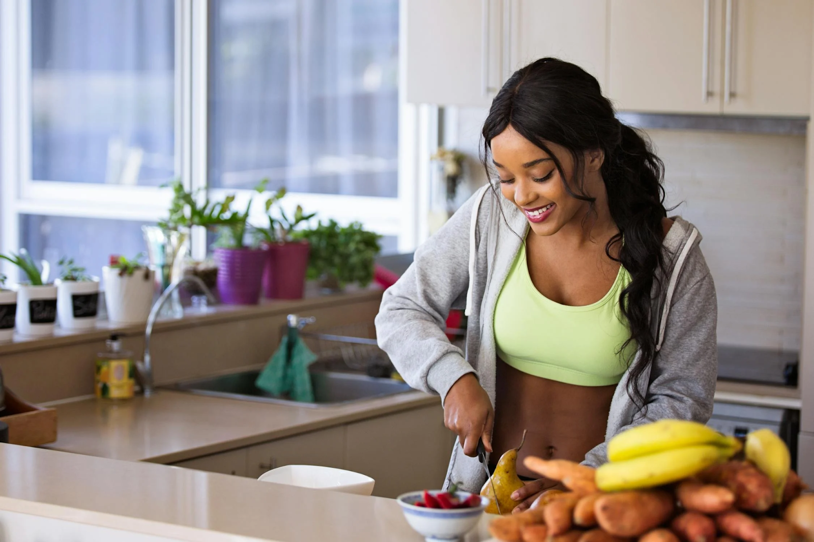 A woman in the kitchen with fruits