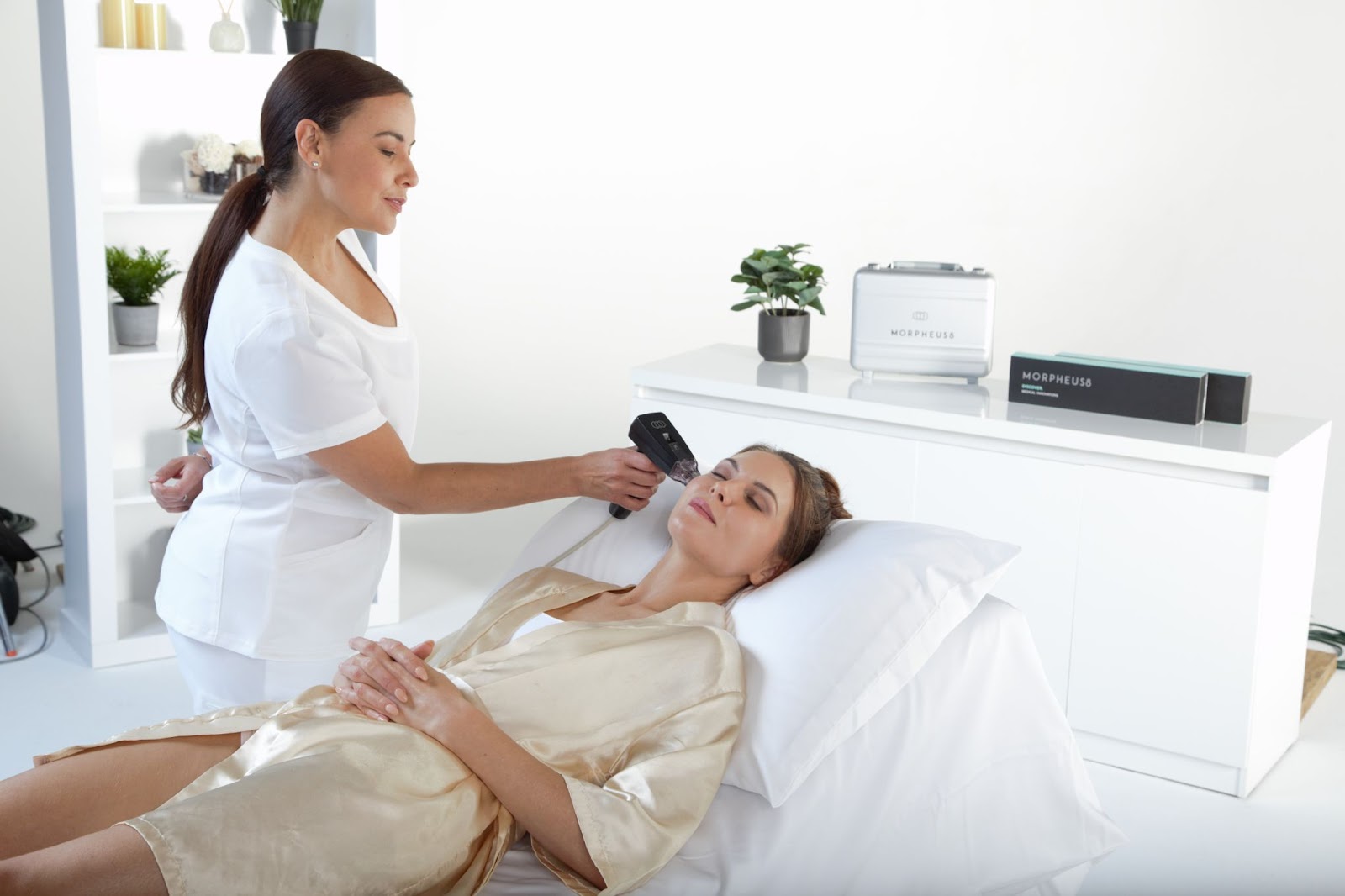 A patient relaxes with her eyes closed as they receive microneedling therapy from a specialist.