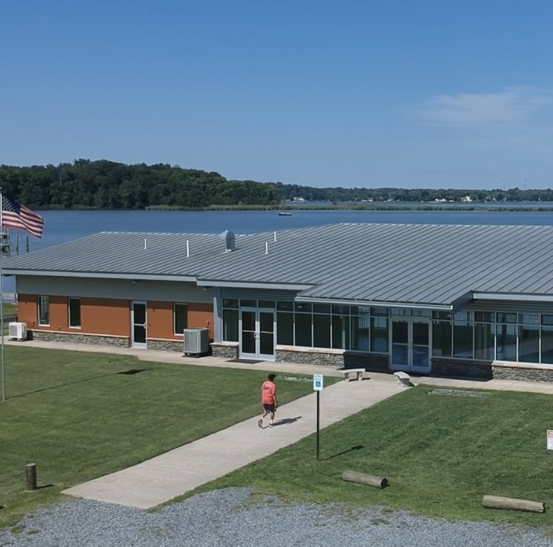 Aerial view of the Selby on the Bay community center, a pre-engineered steel building with large windows overlooking the bay.