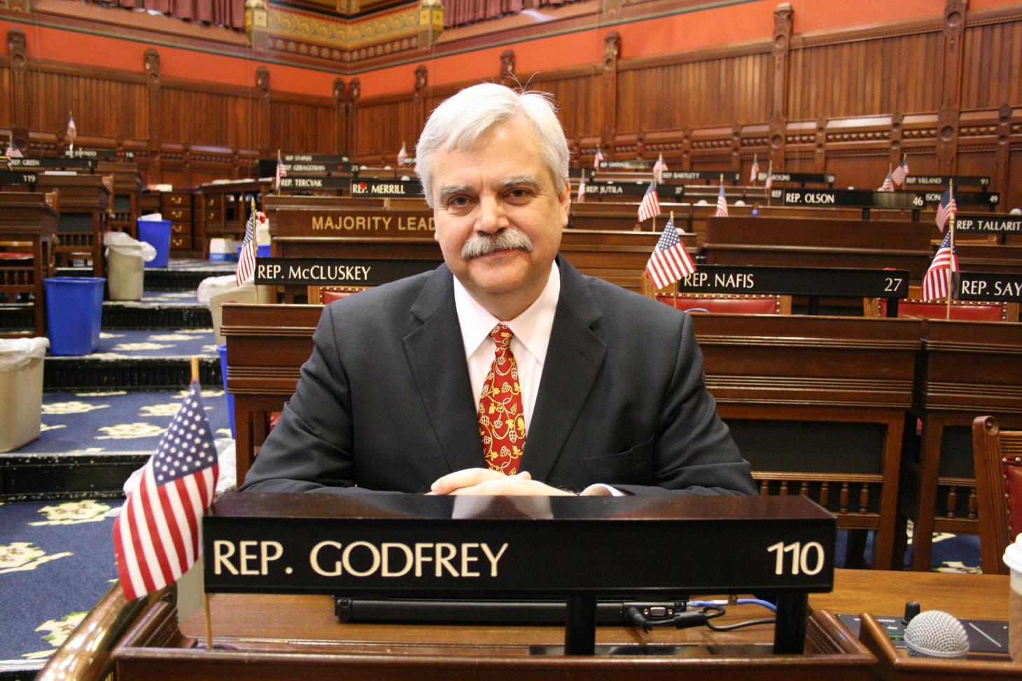 Photo of Bob Godfrey at his State House desk