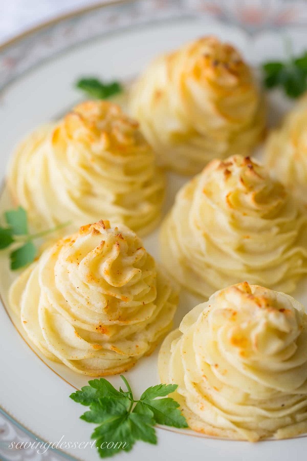 40 Amazing Easter Side Dishes including Duchess Potatoes on a white serving platter