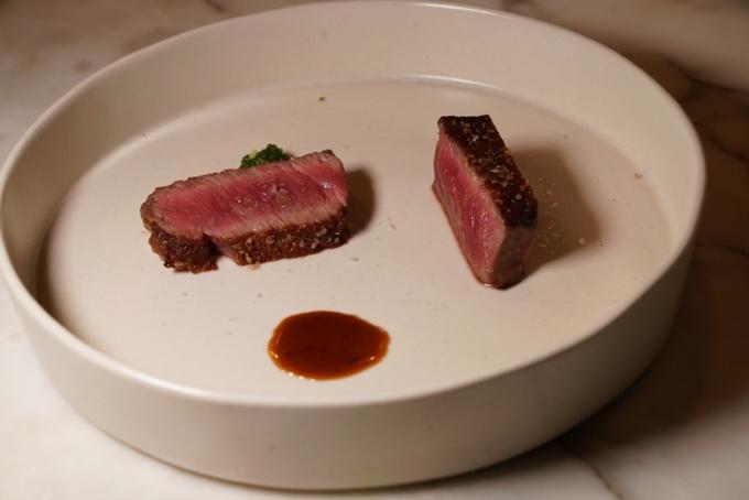 A plate of steak on a marbled surface

AI-generated content may be incorrect.