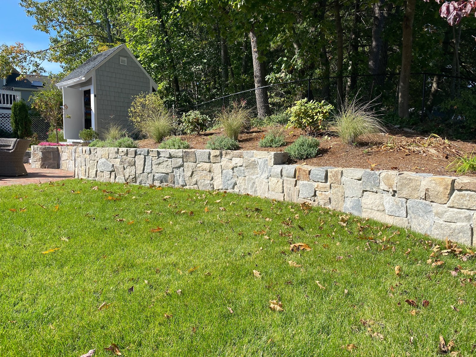 A landscape designer brings a functional retaining wall to a backyard