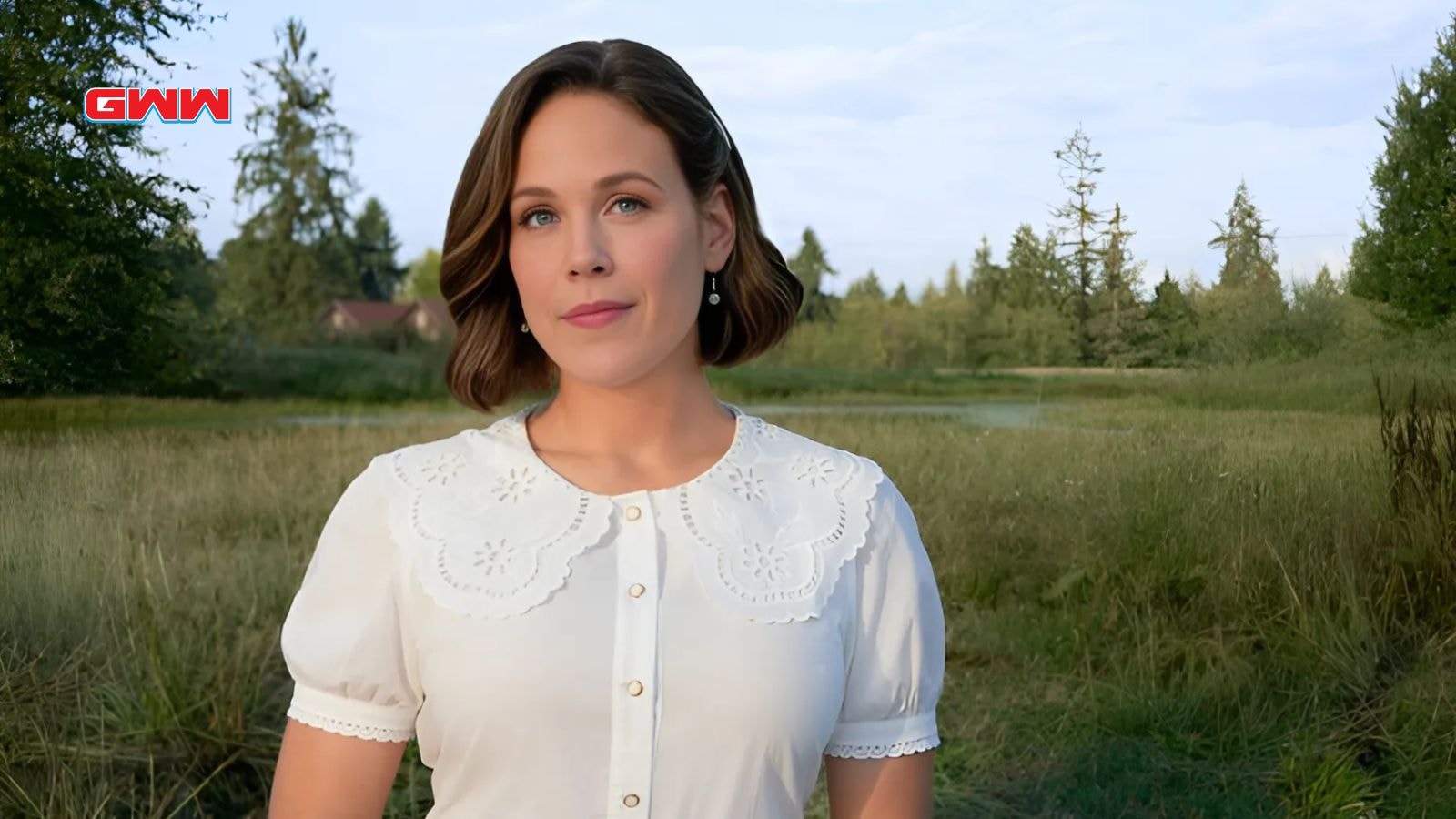 Erin Krakow as Elizabeth Thornton standing in a peaceful outdoor setting.