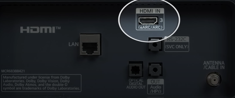 Close-up of a device's HDMI input port labeled eARC/ARC, alongside LAN, optical audio out, and antenna inputs.