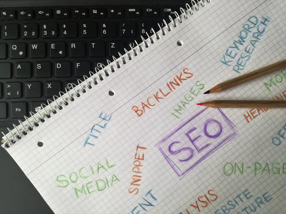 Open notebook with SEO scribbles including words like backlinks, content, keywords, and images
