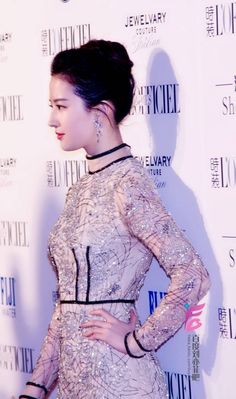 This contains an image of  Liu Yifei in a beautiful dress 