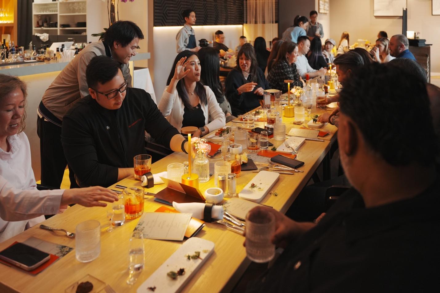 A group of people sitting at a long table

AI-generated content may be incorrect.