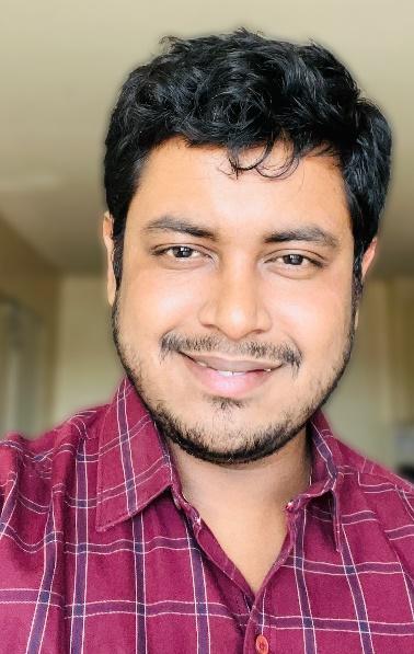 A person smiling for a selfieDescription automatically generated