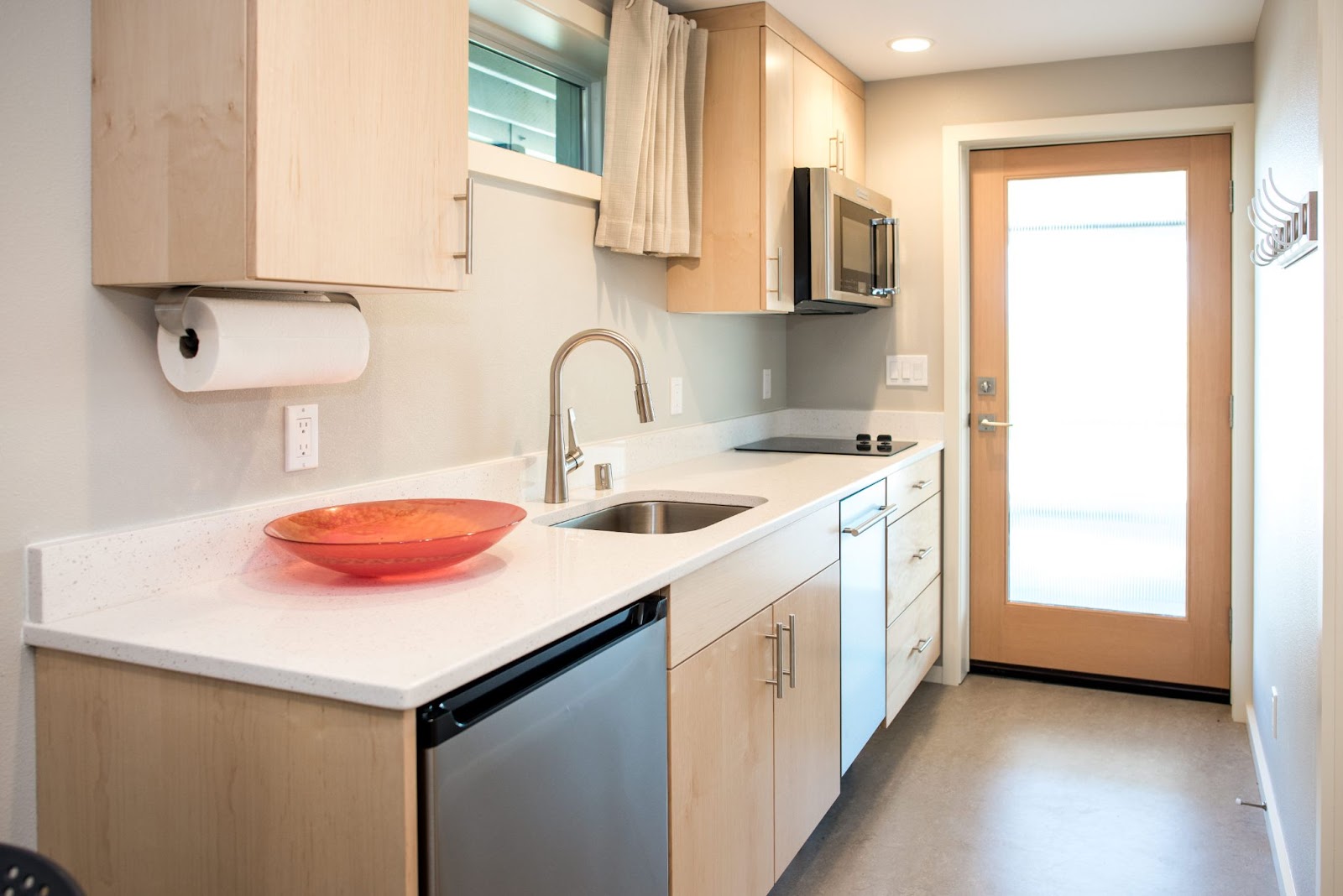 Cooking area in a basement with wooden cabinets