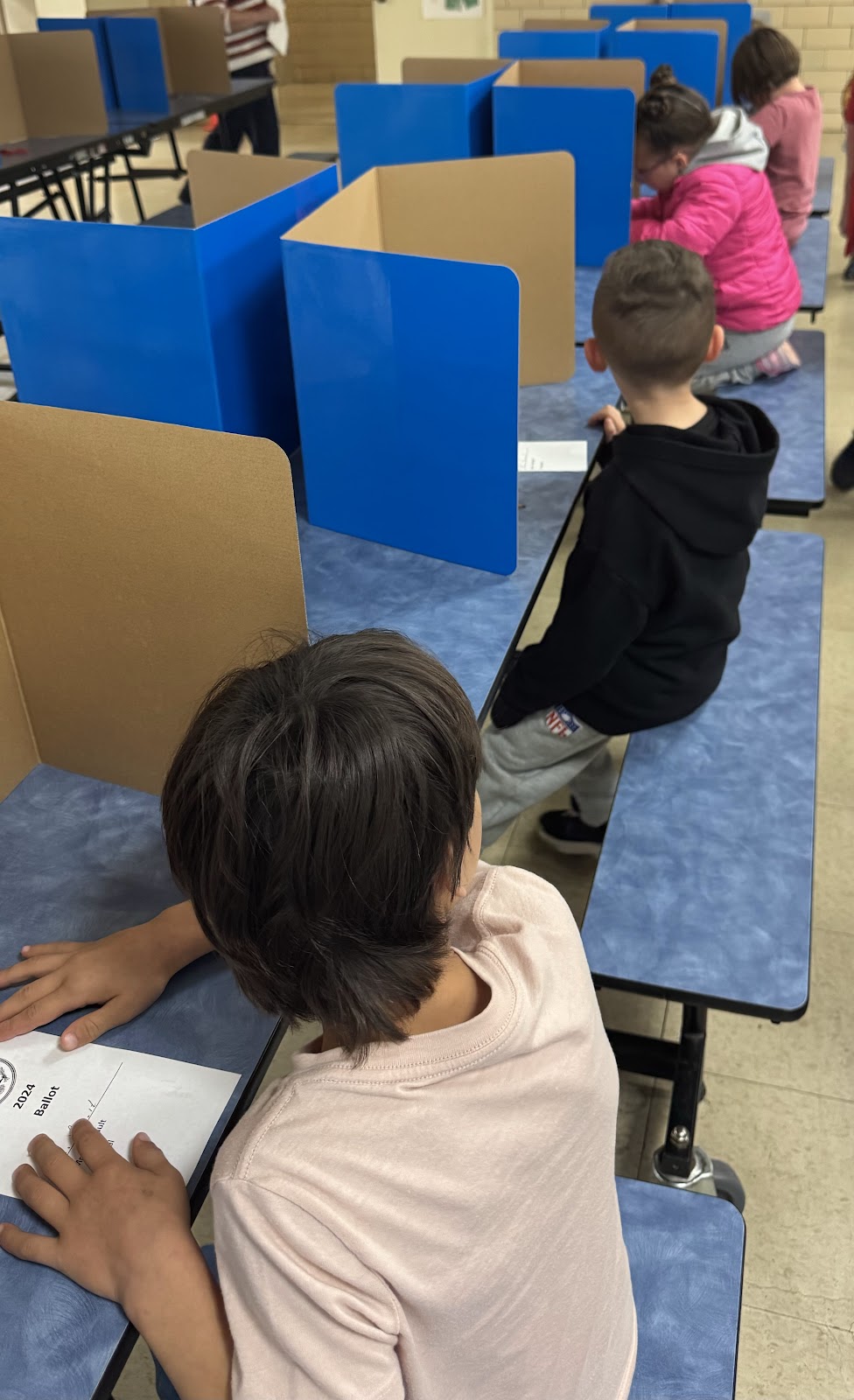 image of students casting their ballots for a mock election