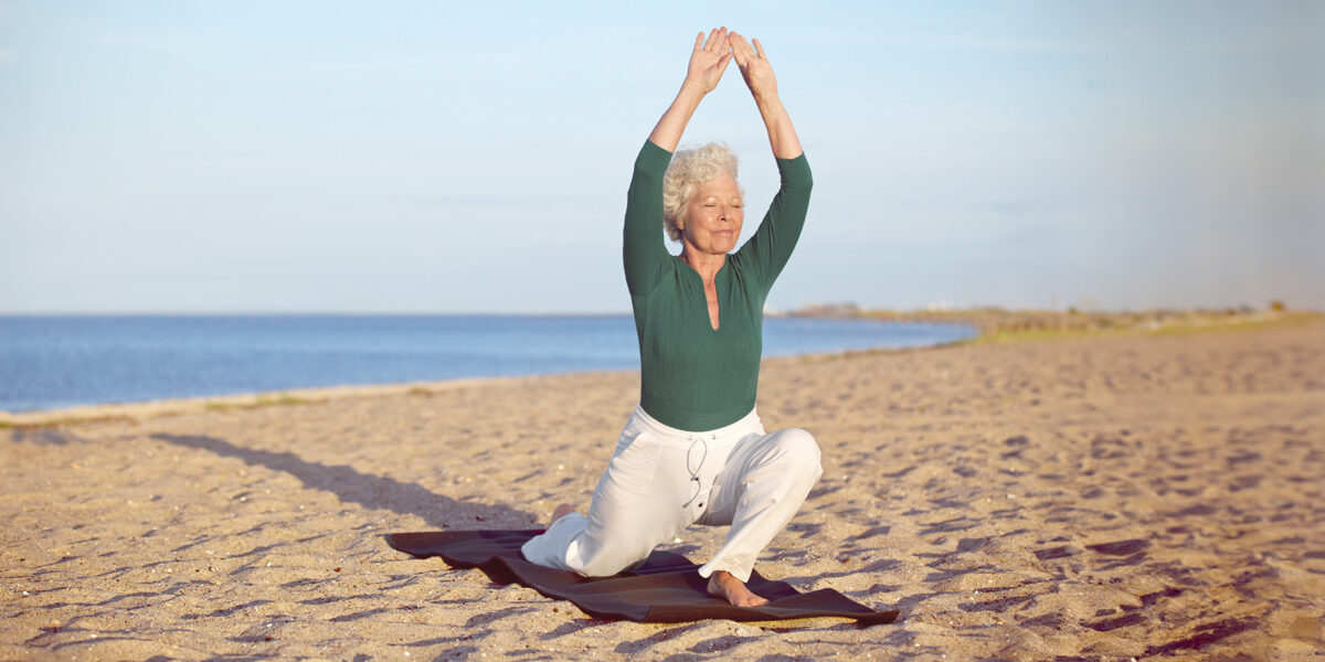 woman stretching on beach