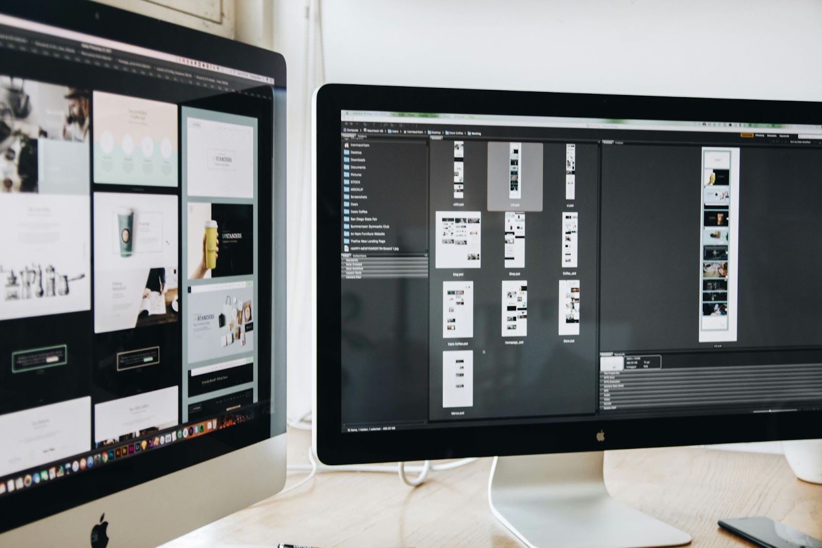 Dual computer monitors showcasing wireframes and visual layouts during the process of UI/UX design for Websites.