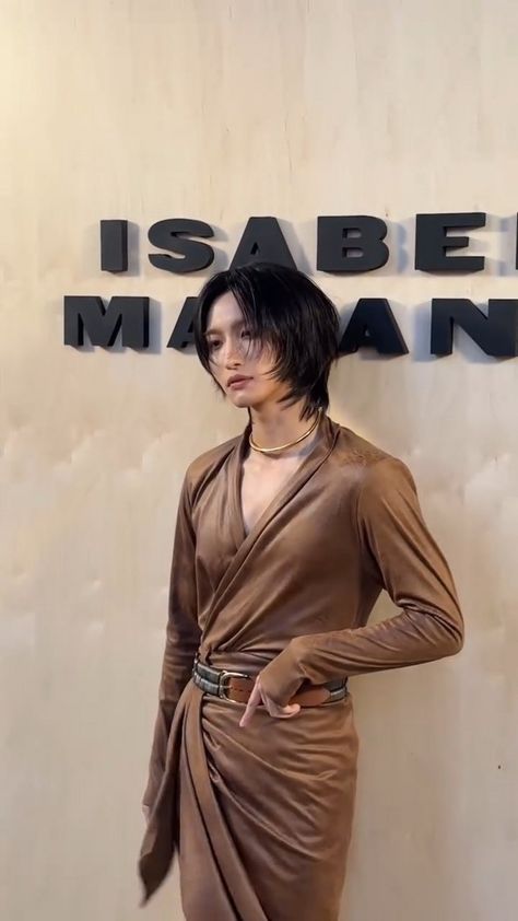 This contains an image of ATEEZ standing in front of a sign that says isaben mannequin