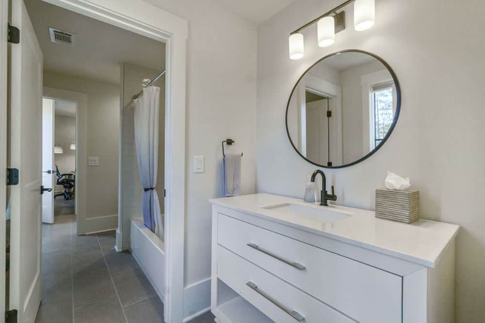 Bathroom with sink vanity and a tub and shower combo.