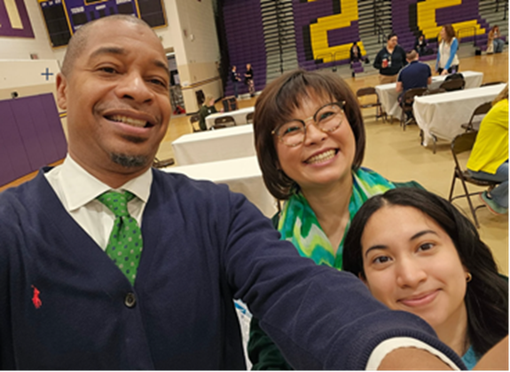 High School student with South Lakes principal and another staffer at the FCPS Instructional Job Fair. 