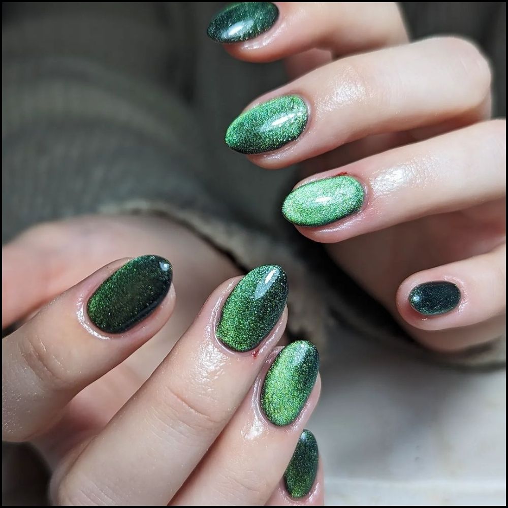 Close up of hands with Christmas Green Nails having  Green Chrome Magic