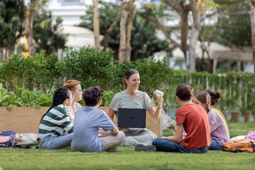A person holding a computer and sitting on the grass

AI-generated content may be incorrect.
