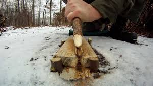 scraping a hardwood stick along a groove carved onto a foundation of softer wood. 
