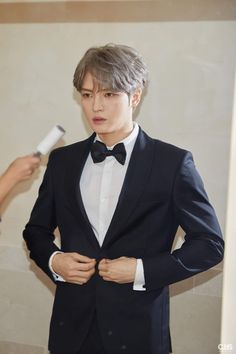  Kim JaeJoong on a white shirt, black bow tie and a black suit 