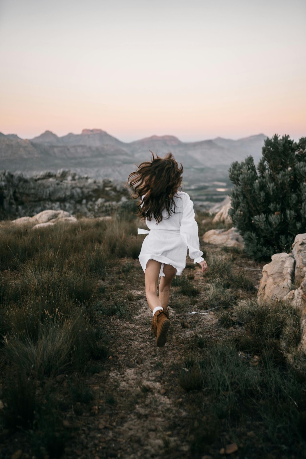 Woman Running on Mountain Trail