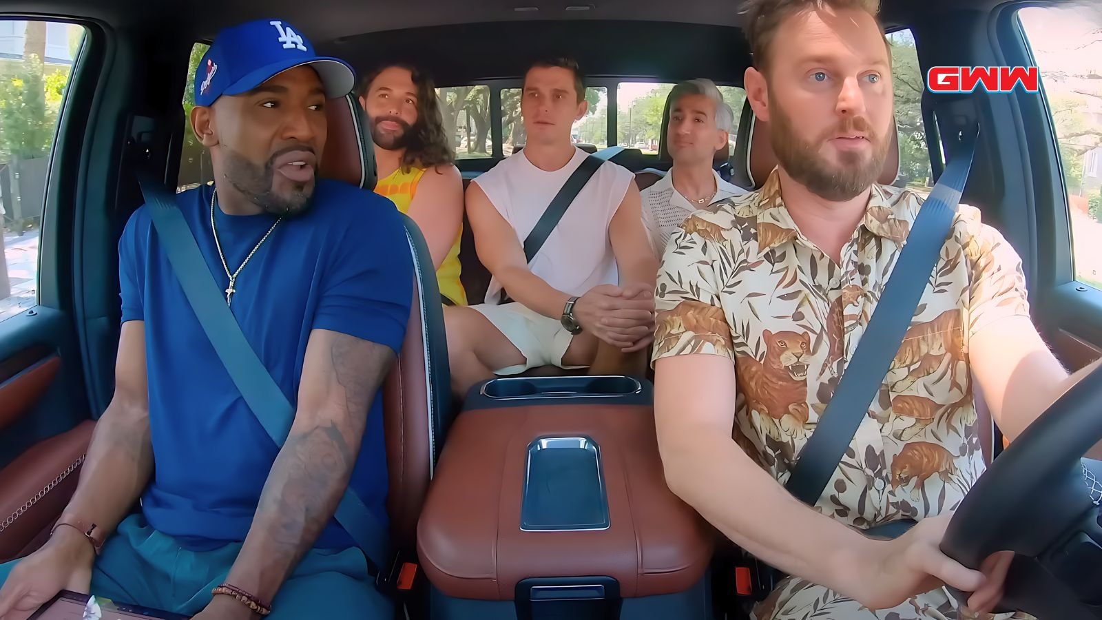 Fab Five seated in a car, engaged in a lively conversation.