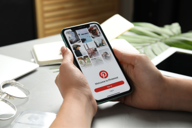 signs your outdoor living space is ready for a remodel homeowner scrolling pinterest on smartphone custom built michigan