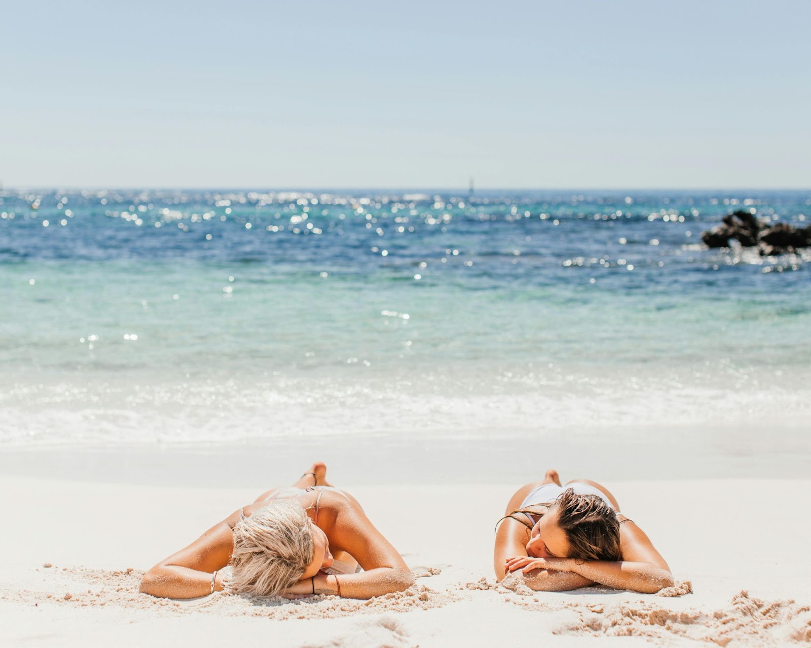 Two women sunbathing.