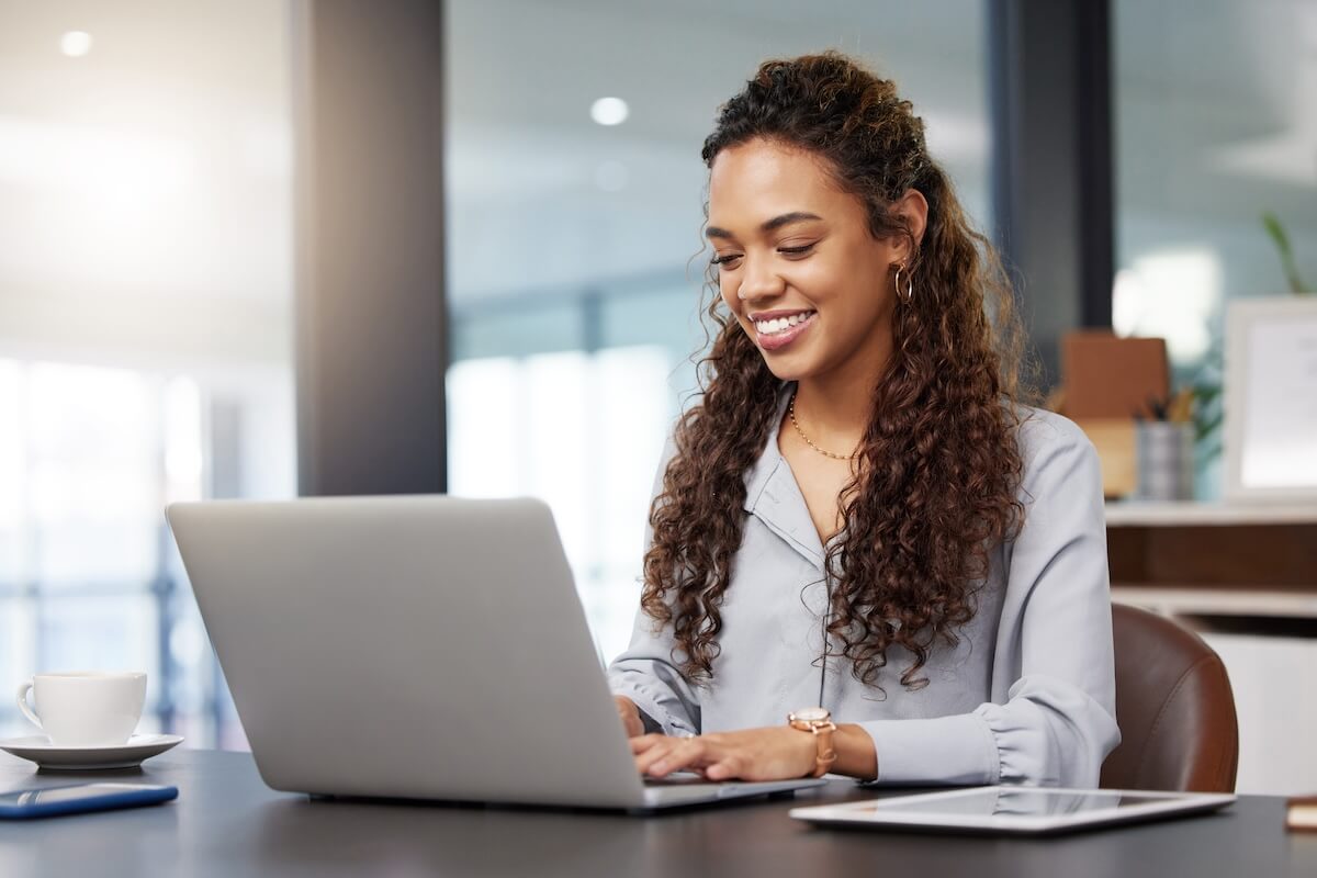 Entrepreneur happily using a laptop