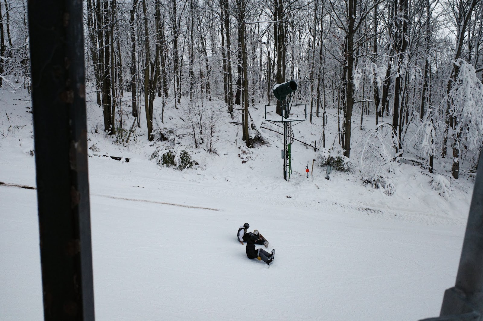 Snowy scene at ski resort with snowboarders