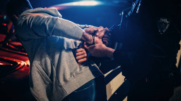 (police officer arresting a man)