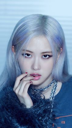 This contains an image of BLACKPINK Rosé's with blue hair posing for the camera