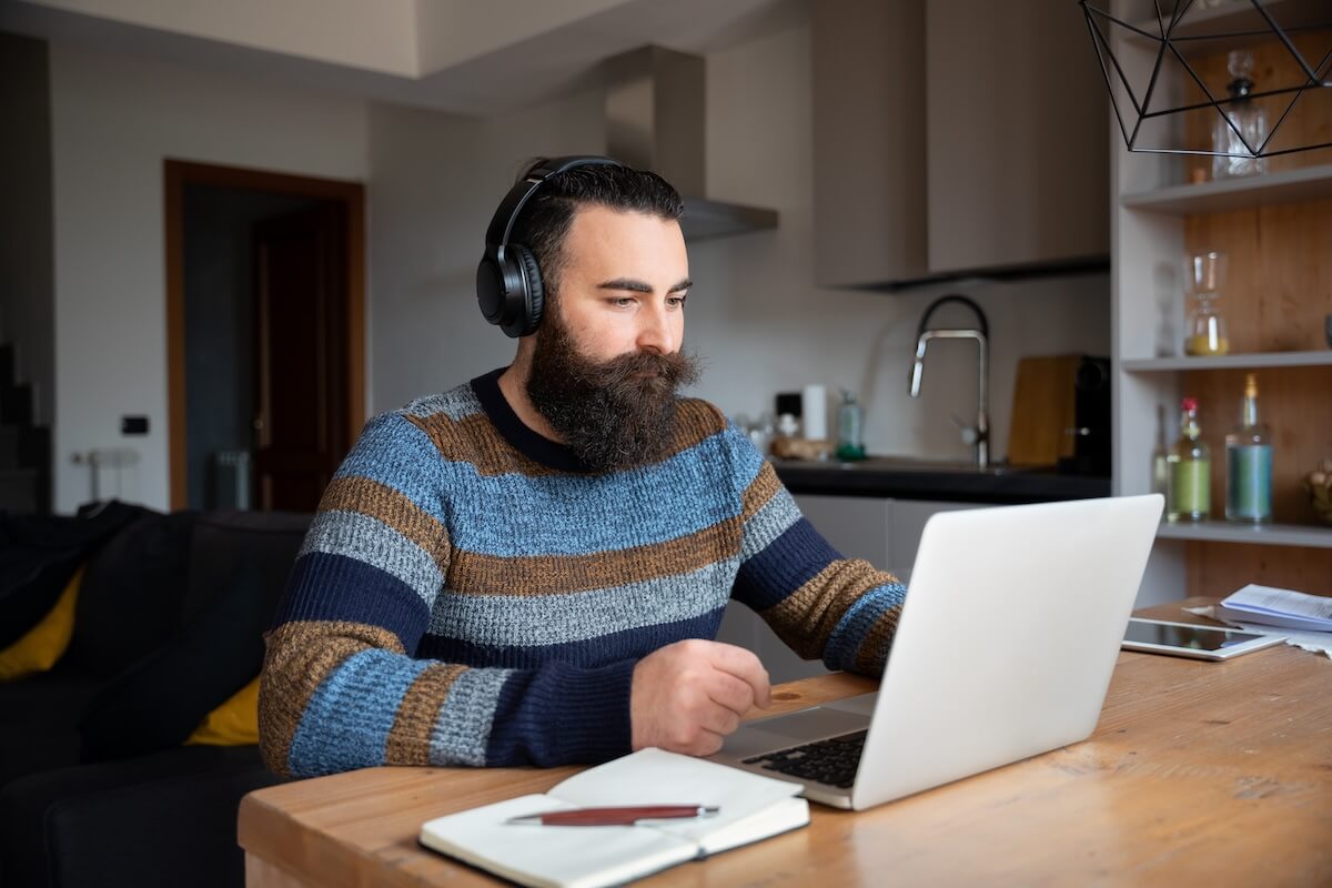 Employee with his headphones on, working from home