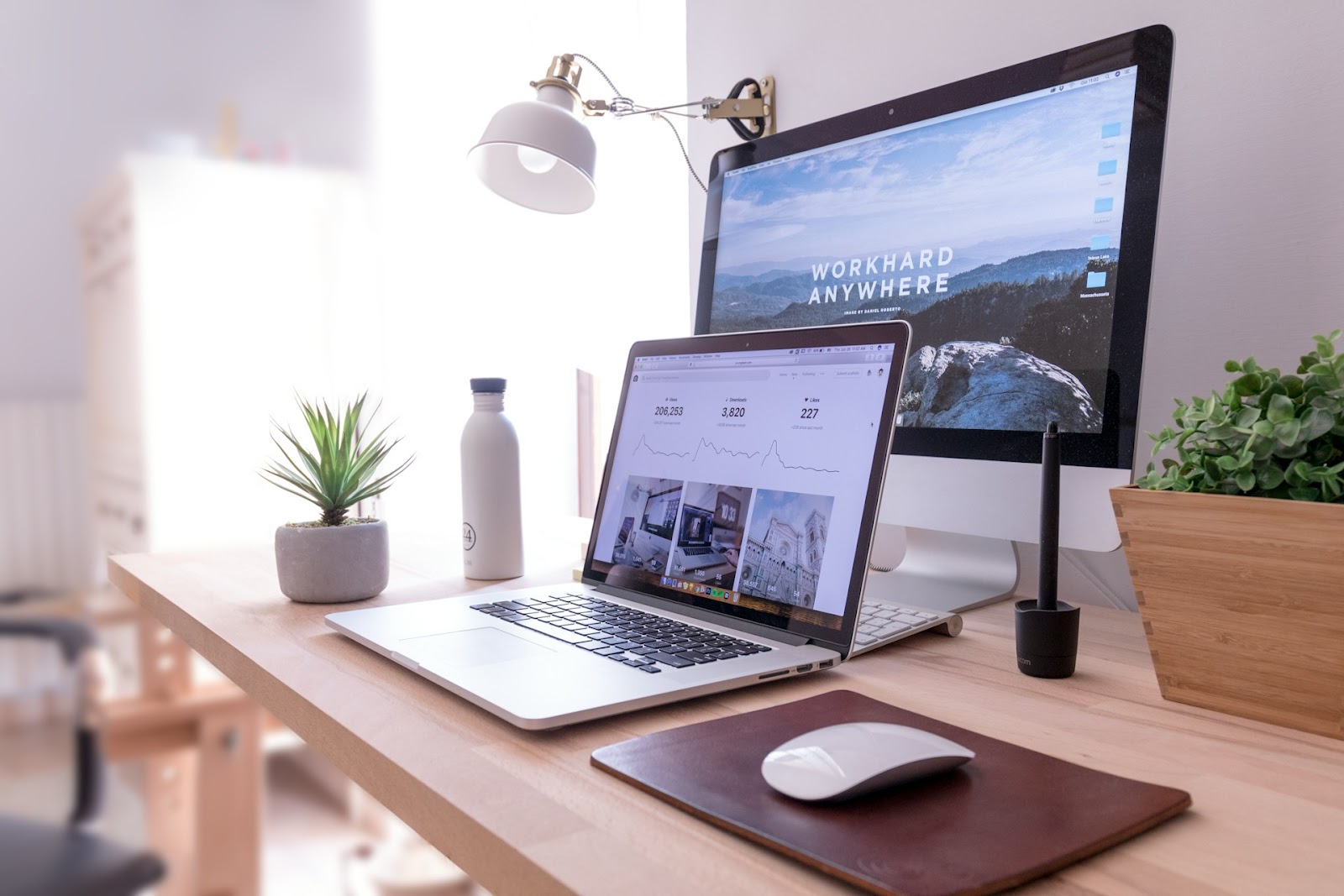 Protect computer from threats. Home office setup with laptop and monitor.