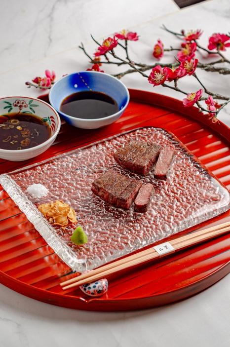 A plate of food on a red tray

AI-generated content may be incorrect.
