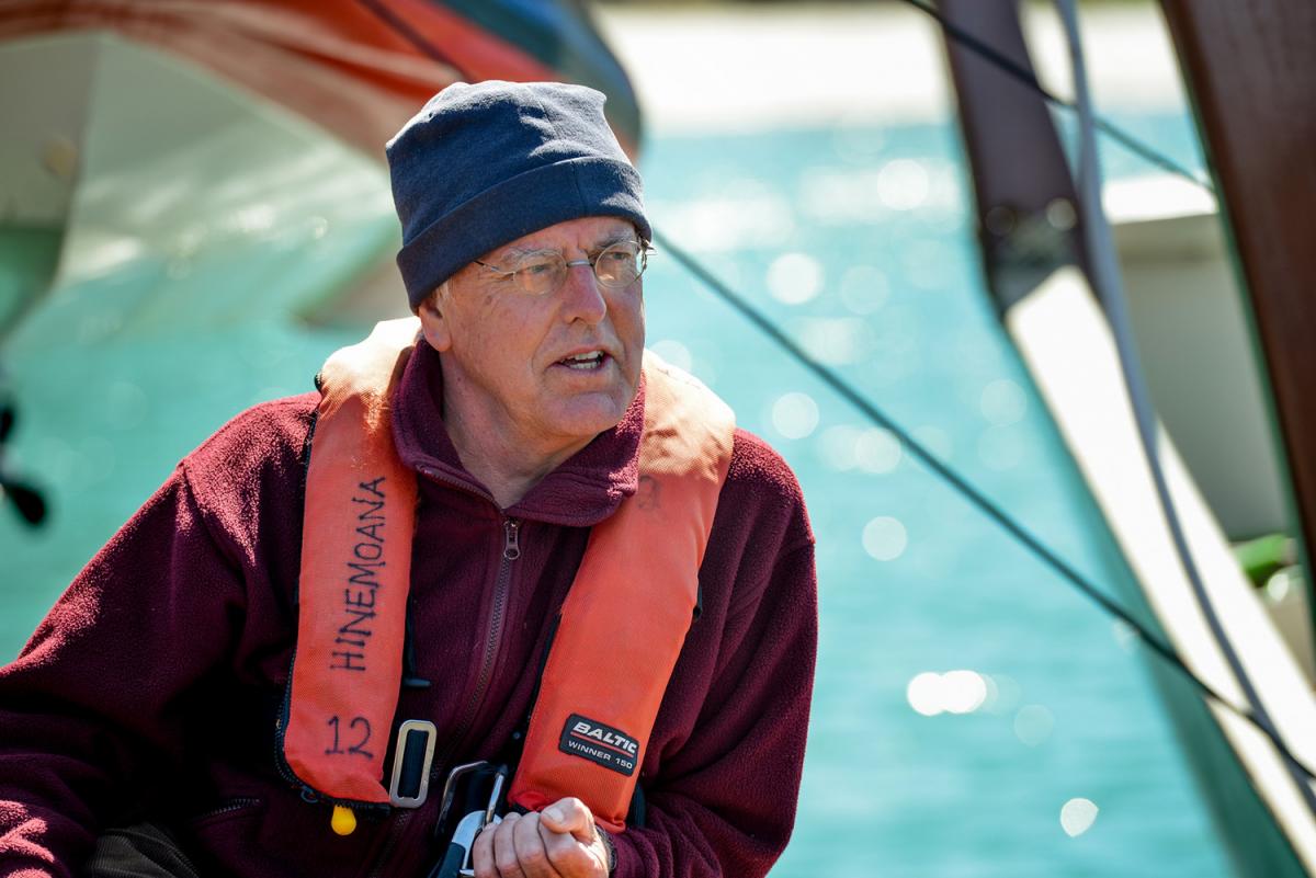 A photo of author Andrew Crowe board the Hinemoana, looking relaxed.