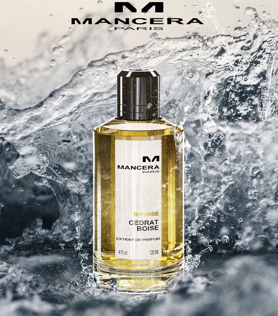 A bottle of Mancera Intense Cedrat Boise Extrait de Parfum with a golden liquid, set against a dynamic water splash background, creating a fresh and luxurious feel.