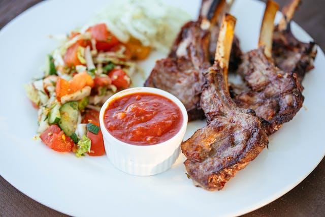 A plate of meat and salad

Description automatically generated