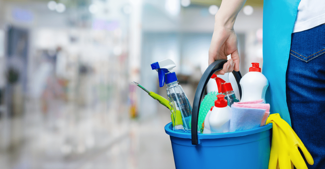 Woman enters storage unit facility with cleaning supplies to clean her storage unit