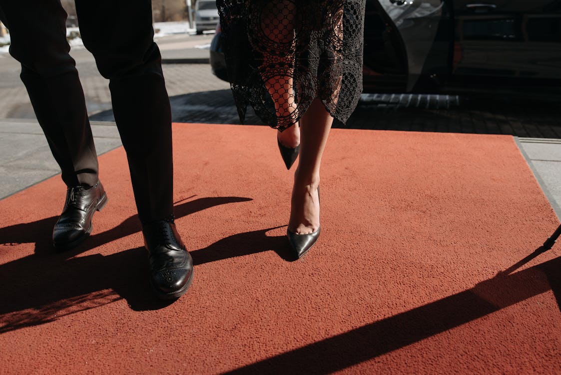 Photo by Pavel Danilyuk: https://www.pexels.com/photo/a-couple-standing-on-the-red-carpet-7594122/ 