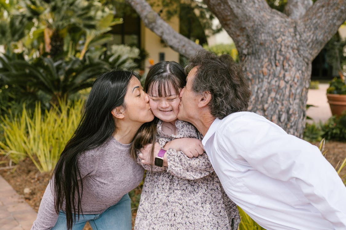 Mom and Dad Kissing Child