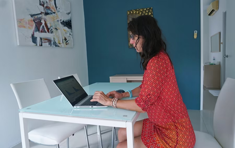 Woman working on blog analytics at home, illustrating why blogging still works for content creators and marketers in 2025.