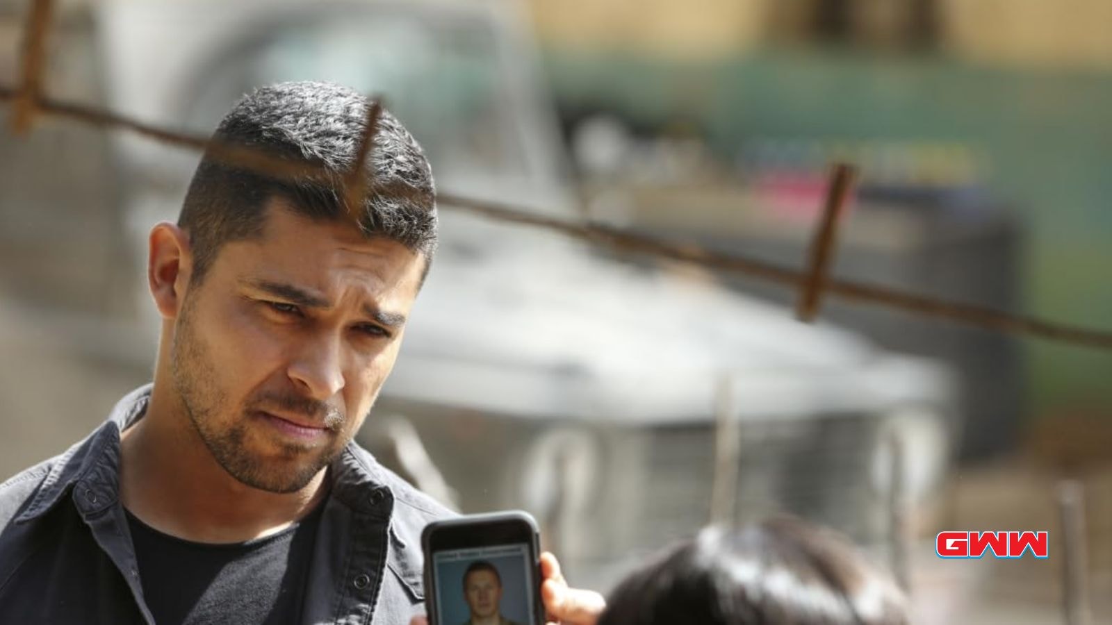 Nick examining a photo of a suspect during an investigation.