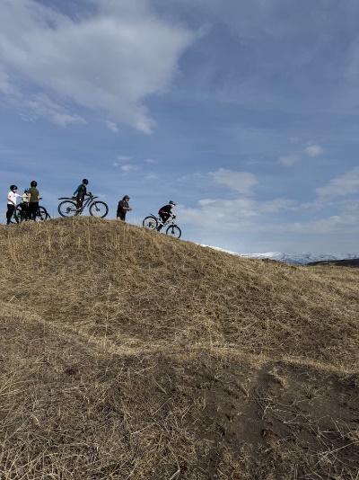 A group of people riding bikes on a hill
AI-generated content may be incorrect.