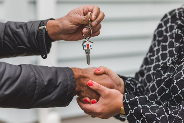 Person passing a set of keys over