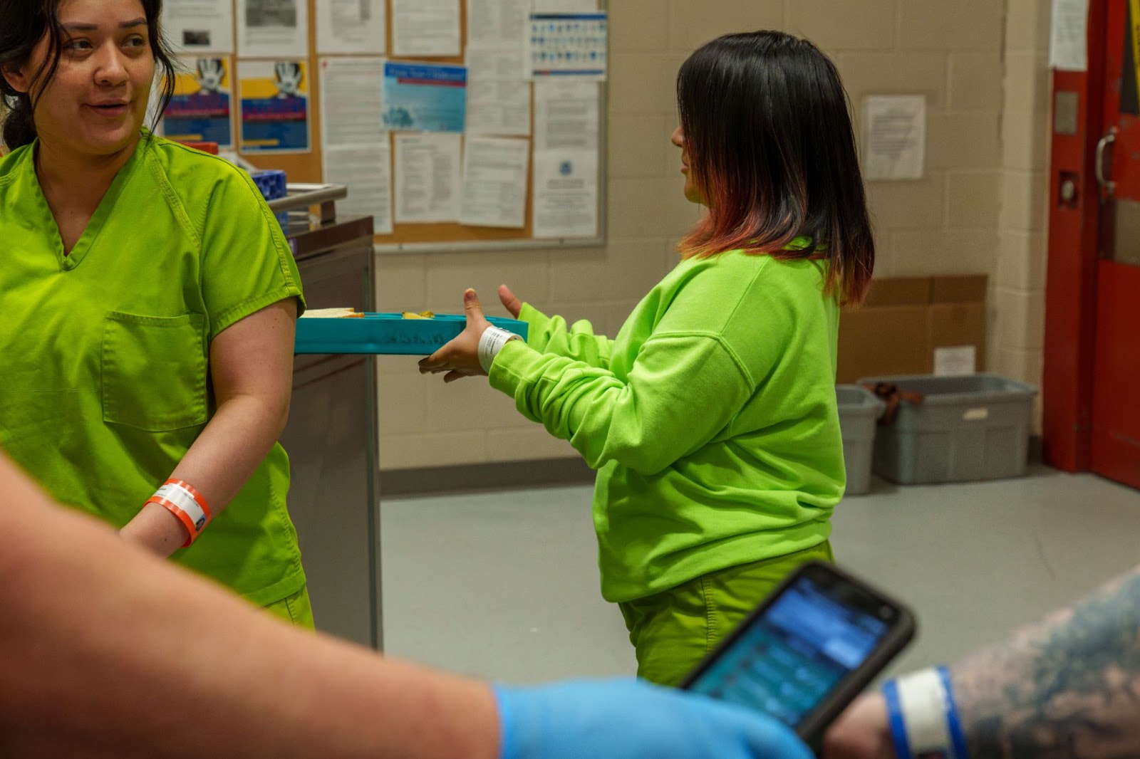 female inmate receiving meal tray