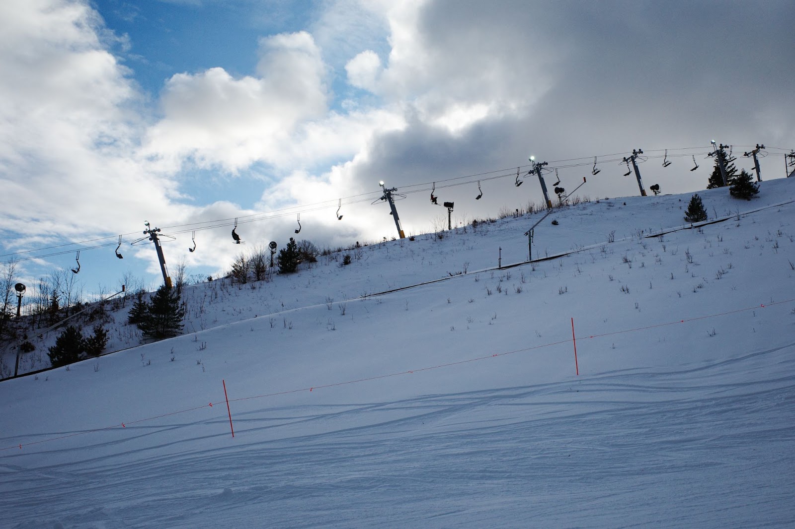 Snowy scene at ski resort with chairlift