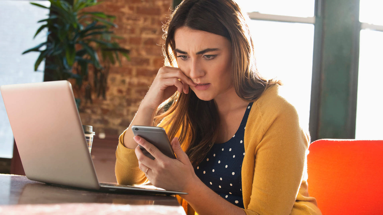 how to ask for your paycheck politely in an email. A young woman wondering how she can do that.
